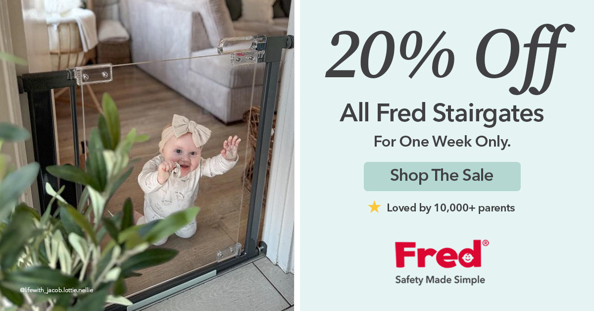 A smiling baby in white stands behind a black stairgate, reaching up. Text beside offers 20% off all Fred Stairgates for one week, with a button to shop and a note loved by over 10,000 parents.