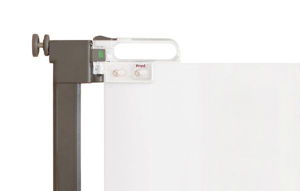 A close-up of a white pressure fit stair gate with a grey handle and a red 'Fred' logo.